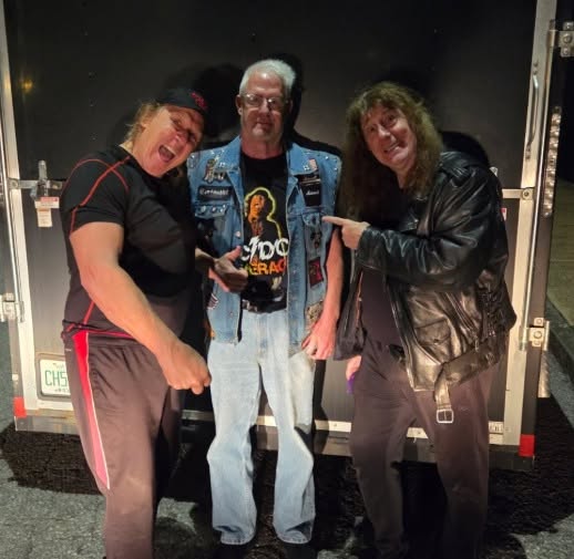 Mark Gallagher of Raven, Wade Brooks and John Gallagher of Raven behind the band's gear trailer in St. Louis